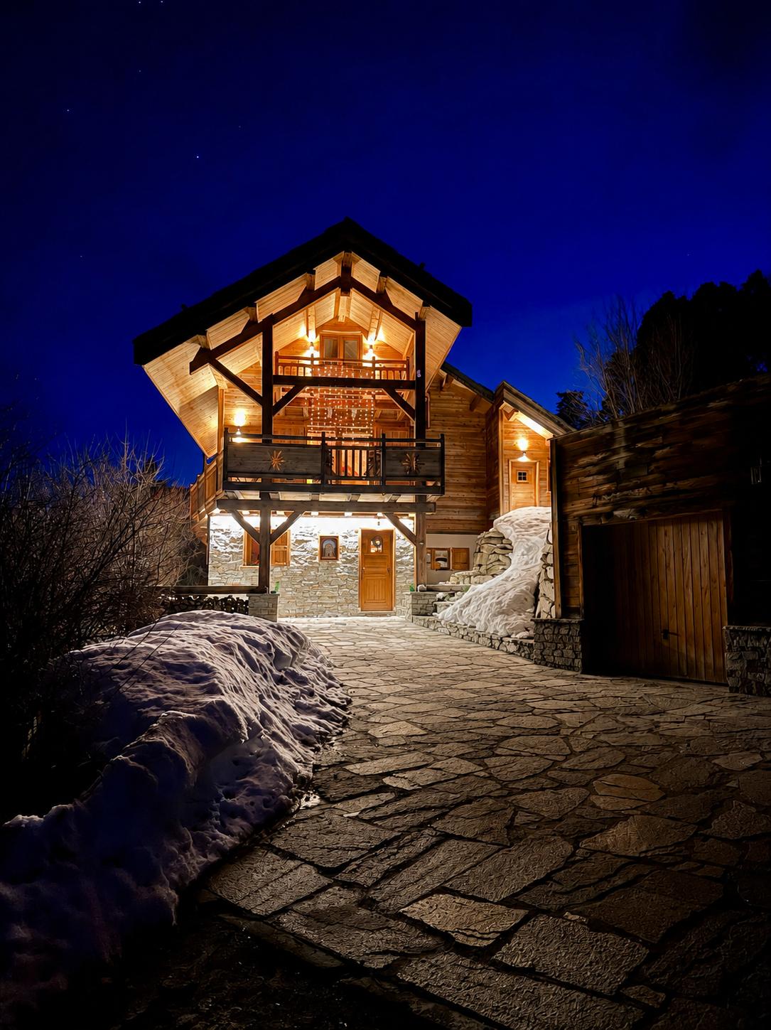 Les Virages chalet glowing at night