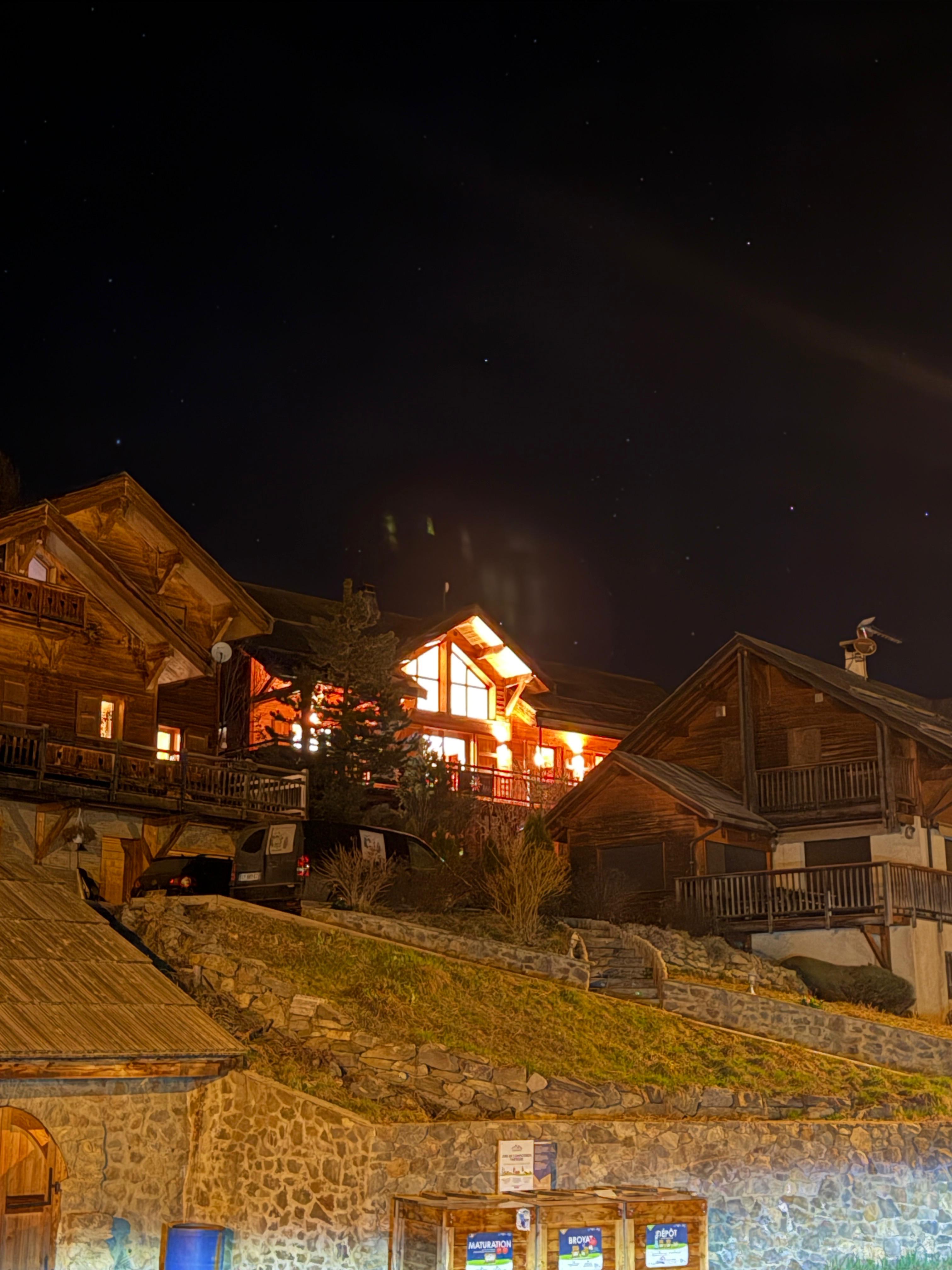 Alpine chalets glowing at night